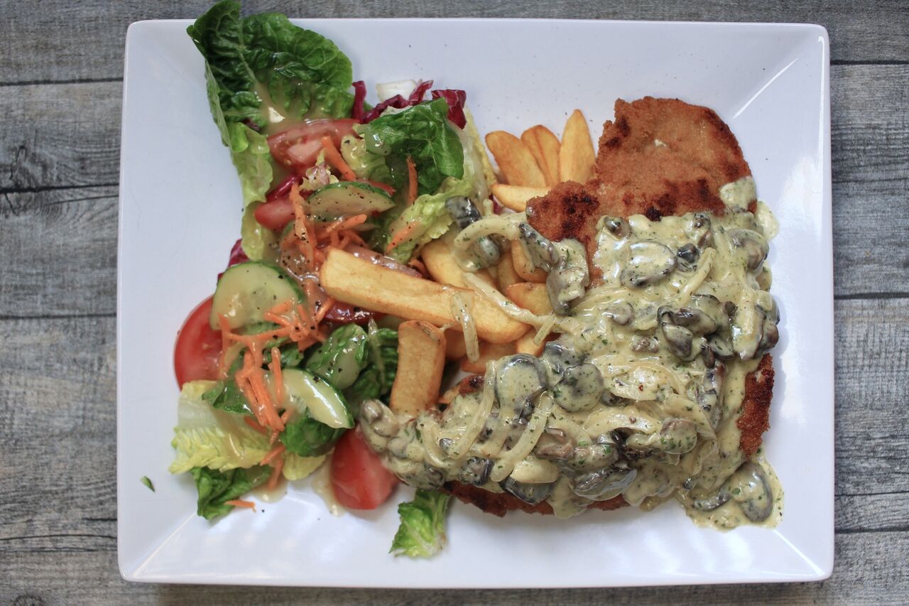 Jägerschnitzel with fries and a side salad with fig dressing