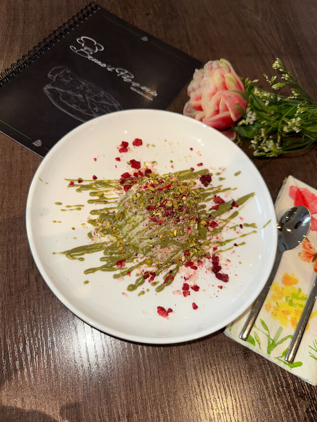 Pistazien Panna Cotta mit weiße Schokoraspeln und Himbeeren