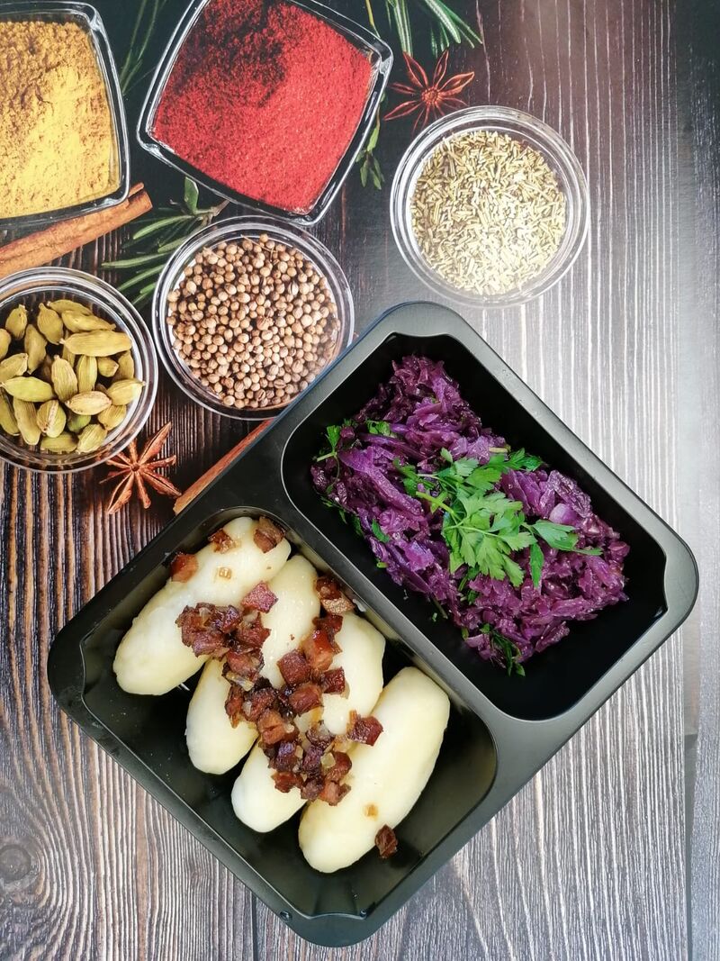 Zestaw kluski z mięsem okraszone boczkiem, surówka z czerwonej kapusty.