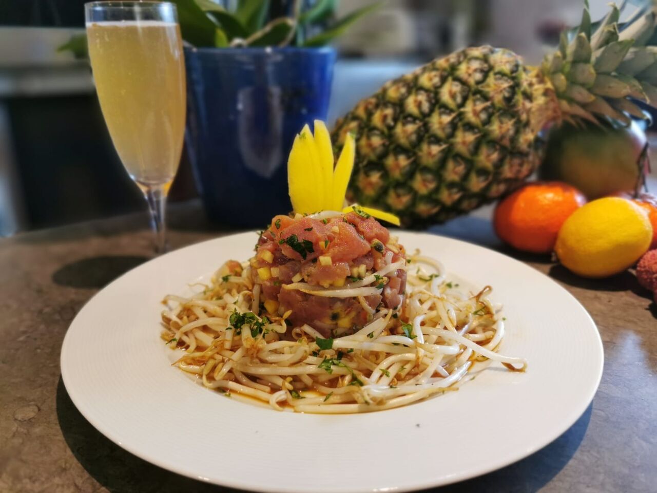 Tartare de thon, gingembre, mangue, pomme et fruit de la passion servi avec des pousses de soja .