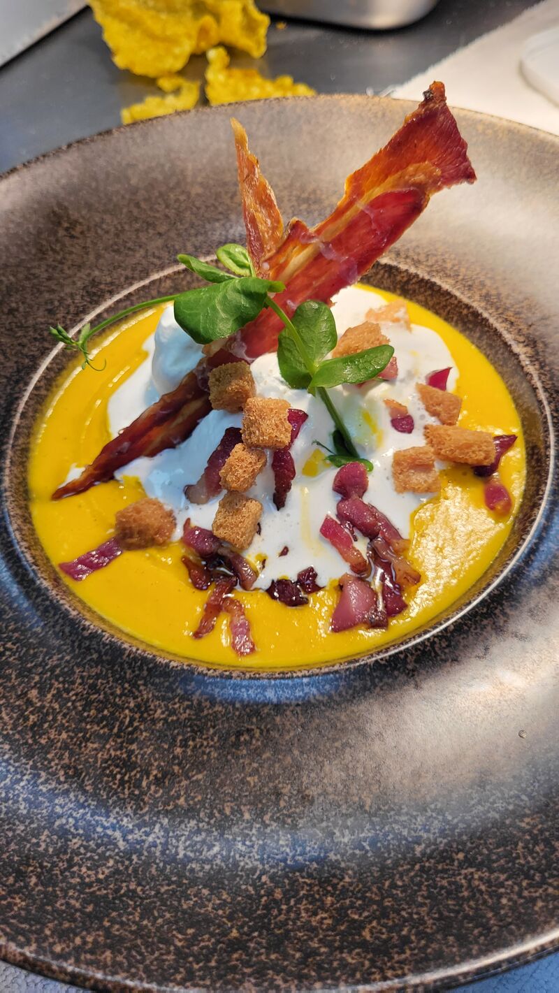 Velouté de courges, émulsion fumée, chips de lard, croûtons, lardons 