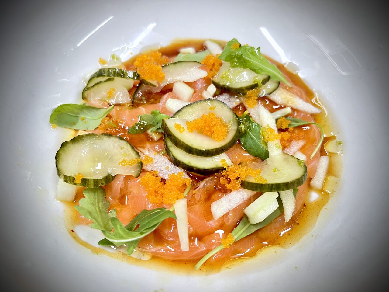 Tiradito de salmón con manzana, pepino y salsa ponzu con kimchee 