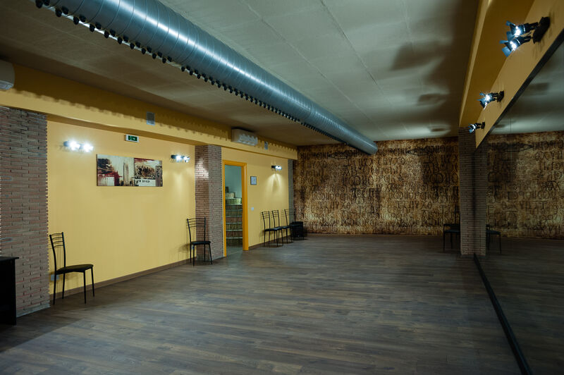 sala inferiore sala di 80 mq con parquet e specchi, parete con scritte celtiche antiche