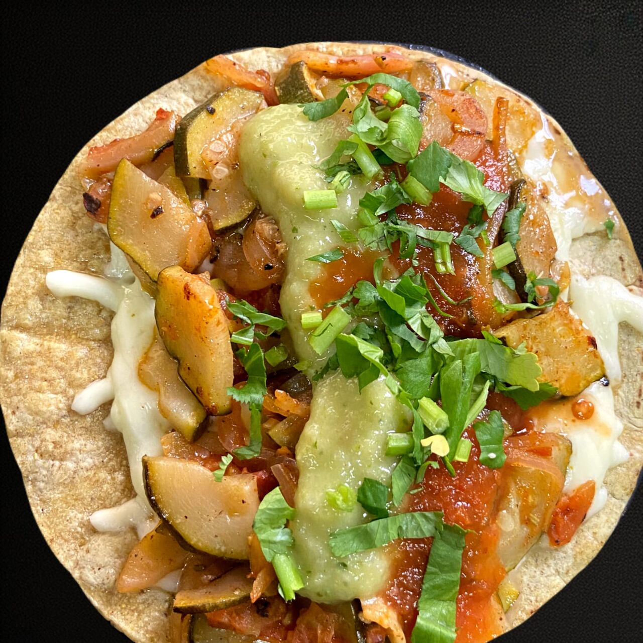 ZUCCHINI QUESADILLA. Herbs, zucchini and onions, melted cheese in a corn tortilla