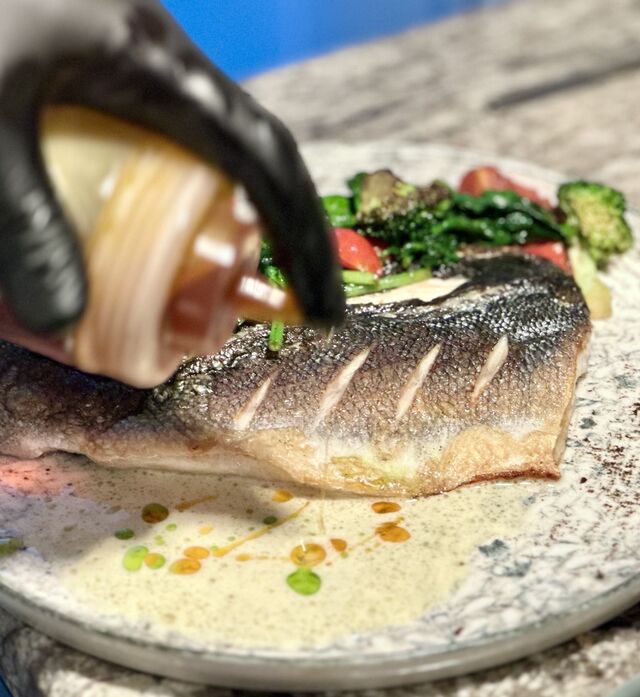 Sea Bass with Broccoli, Baby Spinach, Cherry Tomatoes, and White Wine Sauce with Lumpfish Roe