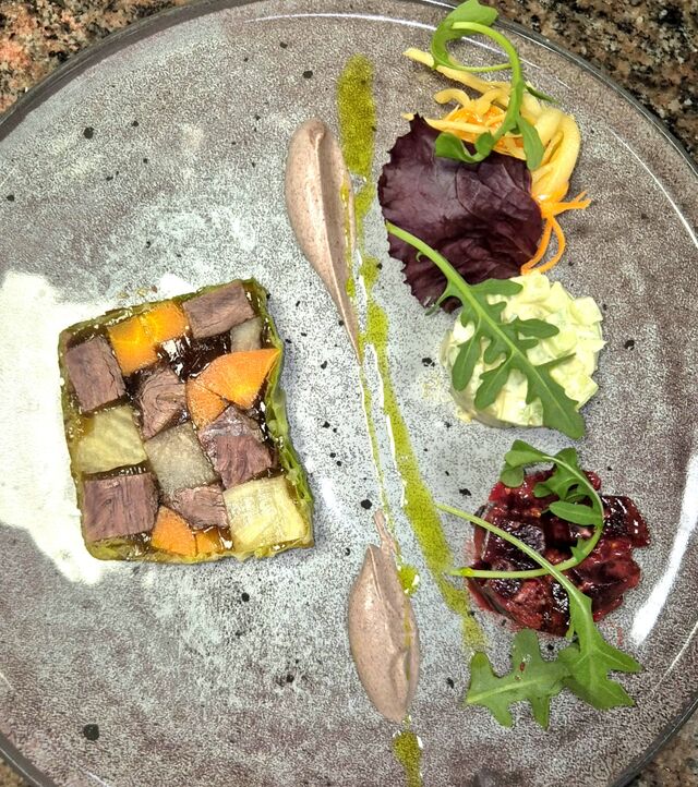 Interprétation d’un bœuf gros sel, servie en gelée, petits légumes de printemps et condiment de moutarde violette.