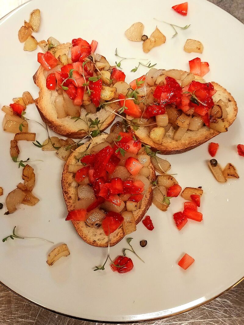 Bruschetta belegt mit gebratenem Spargel, Erdbeeren und grüner Pfeffer