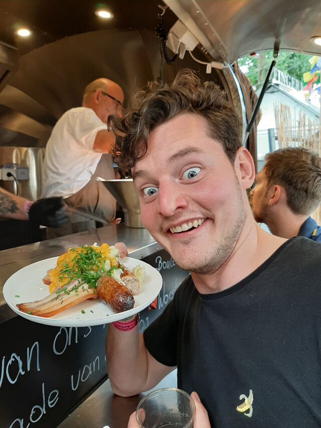 Een blije pukkelpopganger met een bordje boerenkost van 