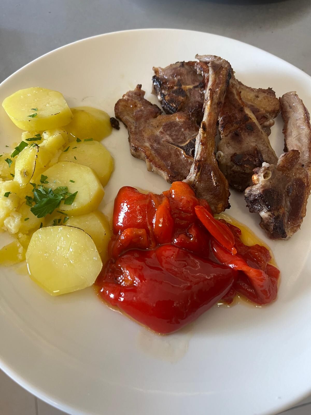Chuletillas de cordero con patatas y pimientos confitados