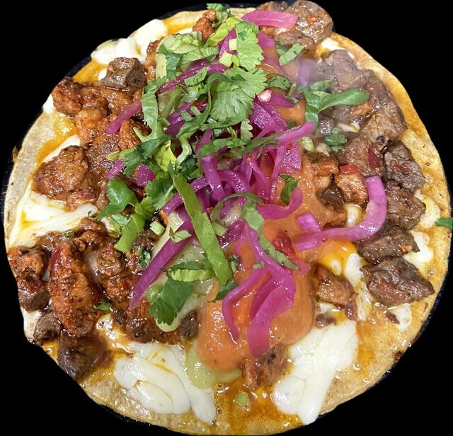 GRINGA AL PASTOR. Pork meat marinated with dry peppers and melted cheese