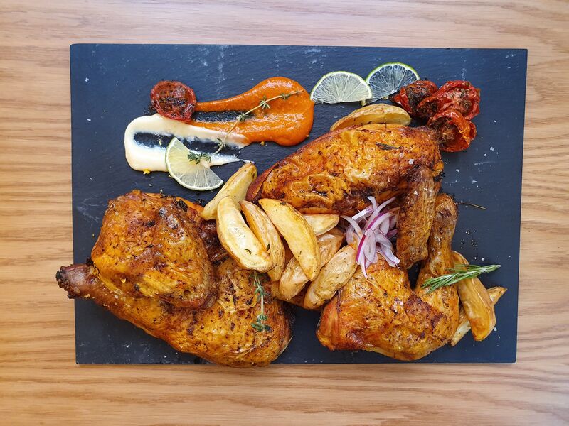 1 Pollo Asado al horno con finas hierbas y toque ahumado, acompañado con patatas rústicas y salsa romesco. 