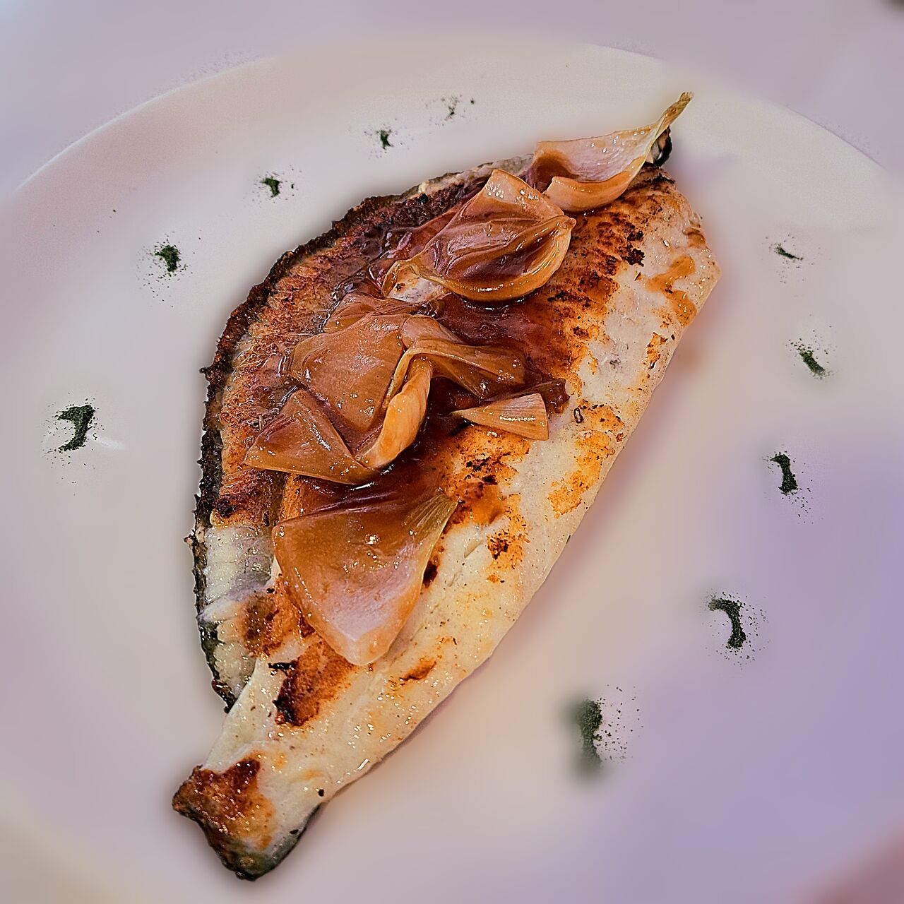 Rodaballo plancha, jugo de carne y cebolla al horno.