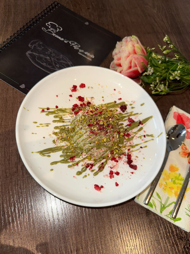 Pistazien Panna Cotta mit weiße Schokoraspeln und Himbeeren